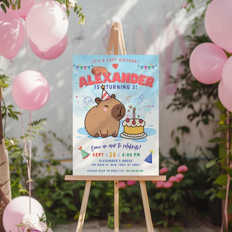 May include: A blue and white birthday party invitation with a cartoon capybara holding a birthday cake. The invitation says "It's a Capy Birthday! Alexander is turning 3!" and includes the date, time, and location of the party.