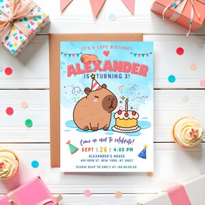 May include: A blue and white birthday invitation with a cartoon capybara wearing a party hat and holding a birthday cake. The invitation says "It's a Capy Birthday! Alexander is turning 3!" and includes the date, time, and location of the party.