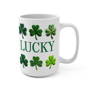 May include: White ceramic mug with a green shamrock design and the word "LUCKY" printed on the front.