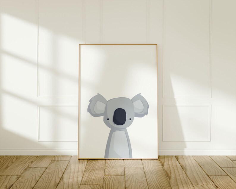 Puede incluir: Una impresi&oacute;n enmarcada de un koala de dibujos animados con pelaje gris y ojos negros. El koala mira hacia la derecha. El fondo es blanco.