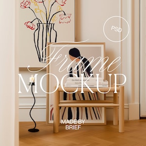 May include: A wooden frame mockup with a colorful abstract painting inside. The frame is sitting on a small wooden stool with a book on top. The text "Frame Mockup" is written in cursive over the image. The text "Made by Brief" is written below the frame.