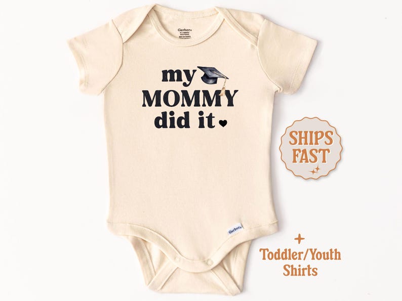 May include: A cream-colored toddler/youth bodysuit with black text that reads "my mommy did it" and a small black graduation cap graphic.