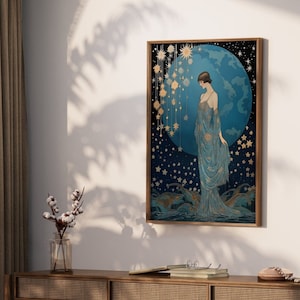 May include: A framed art print featuring a woman in a blue gown standing in front of a blue and gold celestial scene. The scene includes a large blue orb with gold stars and a constellation of smaller stars.