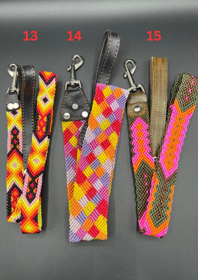 May include: Three colorful woven dog leash handles with leather accents and metal clasps. The handles feature vibrant geometric patterns in shades of red, yellow, orange, pink, purple, and green.