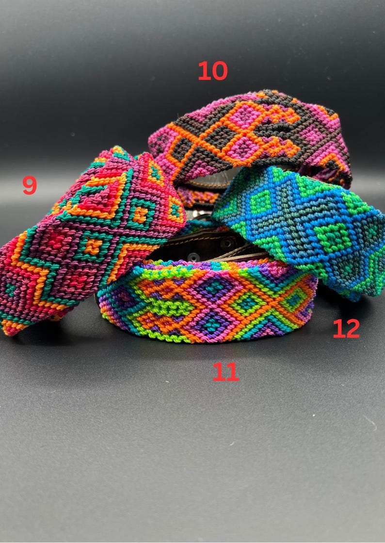 May include: A collection of colorful woven bracelets with geometric patterns. The bracelets feature a variety of colors, including pink, orange, green, and blue. The bracelets are displayed on a dark surface.