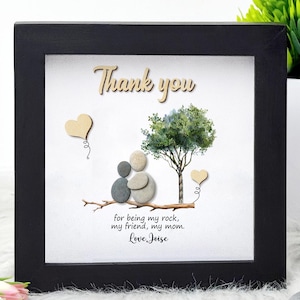 May include: A framed pebble art piece with a tree, two figures holding hands, and the text "Thank you for being my rock, my friend, my mom. Love, Joise."