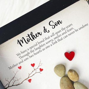 May include: A framed print with a black frame and a white background. The print features a quote about the special bond between a mother and son. The quote reads: "We have a special bond that will span the years Through the laughter, worry, smiles and tears. Mother and son: two hearts as one a link that can never be undone."