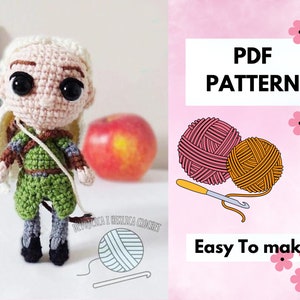 May include: Crochet pattern for a green and brown amigurumi doll with blonde hair. The pattern is available as a PDF download and is easy to make. The image also shows balls of yarn and a crochet hook.