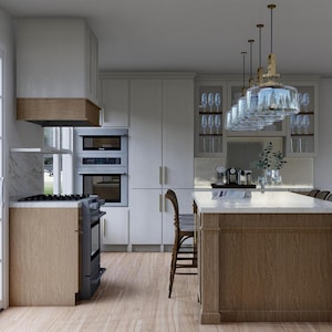 May include: A modern kitchen with light wood cabinets, a large island, and stainless steel appliances. The island has a marble countertop and pendant lights hang above. A stove and oven are visible.