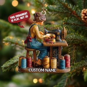 May include: A Christmas ornament featuring a woman sewing on a vintage sewing machine. The woman is wearing a yellow shirt and blue overalls. The ornament has spools of thread in various colors. Text on the ornament reads: "THIS ORNAMENT IS FLAT, NOT 3D" and "CUSTOM NAME."