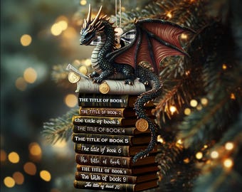 May include: A fantasy-themed Christmas ornament featuring a black and bronze dragon perched atop a stack of books. The dragon has red wings and is surrounded by gold coins. The books are labeled "The Title of Book 1" through "10".