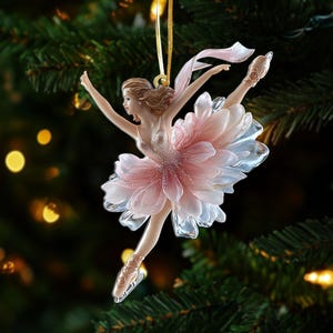 May include: A decorative Christmas ornament of a ballerina in a graceful pose. The ornament features a pink and white flower-shaped tutu, a gold ribbon, and a delicate design. The ballerina is poised mid-leap, with arms outstretched.