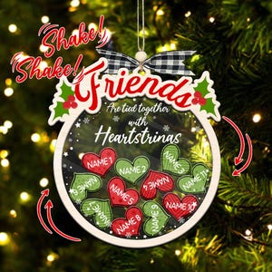 May include: White wooden ornament with a red and green heart design. The ornament has the text "Friends are tied together with heartstrings" and space for 10 names.
