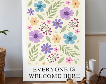 May include: A white canvas print with a floral pattern in shades of purple, blue, pink, and yellow. The text "Everyone is Welcome Here" is printed at the bottom of the canvas.