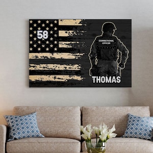 May include: Black and white American flag with a distressed woodgrain texture. A silhouette of a correctional officer stands in front of the flag. The officer is wearing a black uniform and a helmet. The text "Correctional Officer" and "Thomas" is printed on the flag.