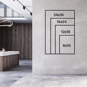May include: A white wall with four black frames showing different sizes of prints. The frames are labeled with the dimensions of the prints: 24x36, 16x24, 12x18, and 8x10.