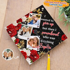 May include: A black graduation cap decorated with red roses, butterflies, and photos. The cap has the text "I wanted to give up but then I remembered who was watching Sophia." A yellow tassel hangs from the cap.