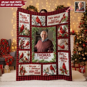 May include: A personalized memorial blanket featuring a central photo of a man, surrounded by images of red cardinals and text. The blanket has a red and black plaid border and includes the text "Those we love don't go away" and "They walk beside us every day."