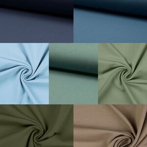 May include: A collection of fabric swatches in various shades of blue, green, and brown. The fabric is a soft, textured knit.