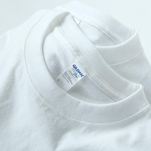 May include: Close-up of two white crew neck t-shirts. The Gildan Premium Cotton label is visible on one shirt, with the size "S" printed on the label. The shirts are made of a soft, likely cotton material.
