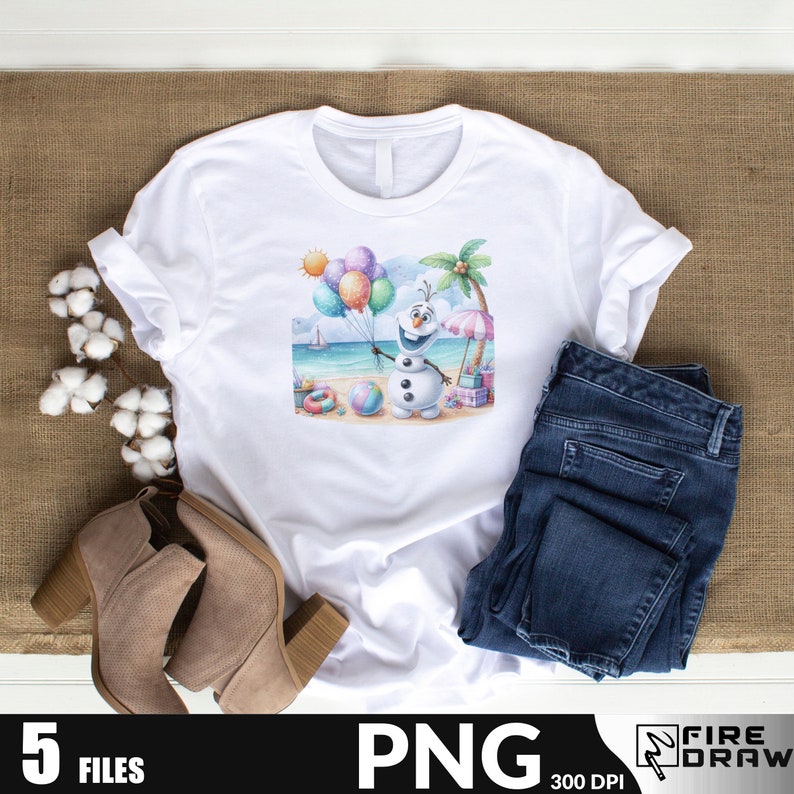 May include: A white t-shirt with a colorful illustration of a snowman holding balloons on a beach. The snowman is wearing a blue scarf and has a carrot nose. The beach scene includes a palm tree, an umbrella, and a beach ball.
