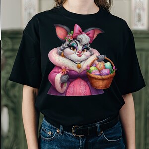 May include: A black t-shirt with a colorful illustration of a bunny rabbit wearing a pink dress and holding a basket of Easter eggs.