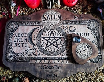 May include: A wooden Ouija board with a pentagram design, a planchette, and the words "Salem Witchcraft since 1692" and "Good Bye".