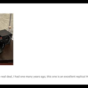 May include: A black vintage camera with a large lens and a top-mounted viewfinder. The camera is on a dark surface. The image includes text that says "Frank on Oct 20, 2024" and a customer review.