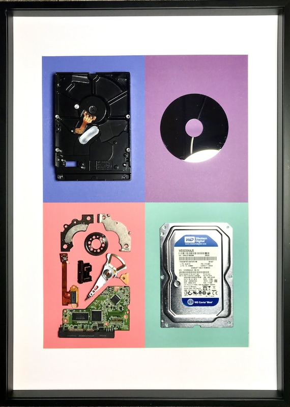A hard drive torn down and reassembled as wall sculpture — platters, read heads, and magnets arranged like industrial fine art with real demand (18 faves).