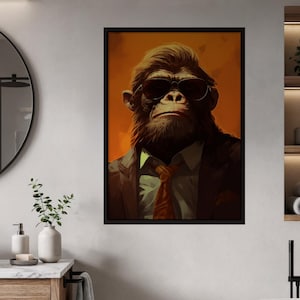 May include: Framed art print featuring a chimpanzee wearing sunglasses, a suit jacket, and a tie. The artwork has a warm color palette with an orange background. The chimpanzee has a serious expression.