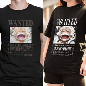 May include: Black t-shirt with a graphic print of a wanted poster featuring a cartoon character with the text "WANTED DEAD OR ALIVE? MONKEY D LUFFY $3,000,000,000 - MARINE".