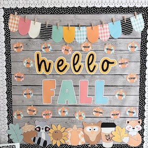 May include: A classroom bulletin board decorated for fall with a wooden plank background. The board features a banner with colorful scalloped shapes, the words "hello fall" in yellow and black lettering, and student names written on small pumpkin cutouts.
