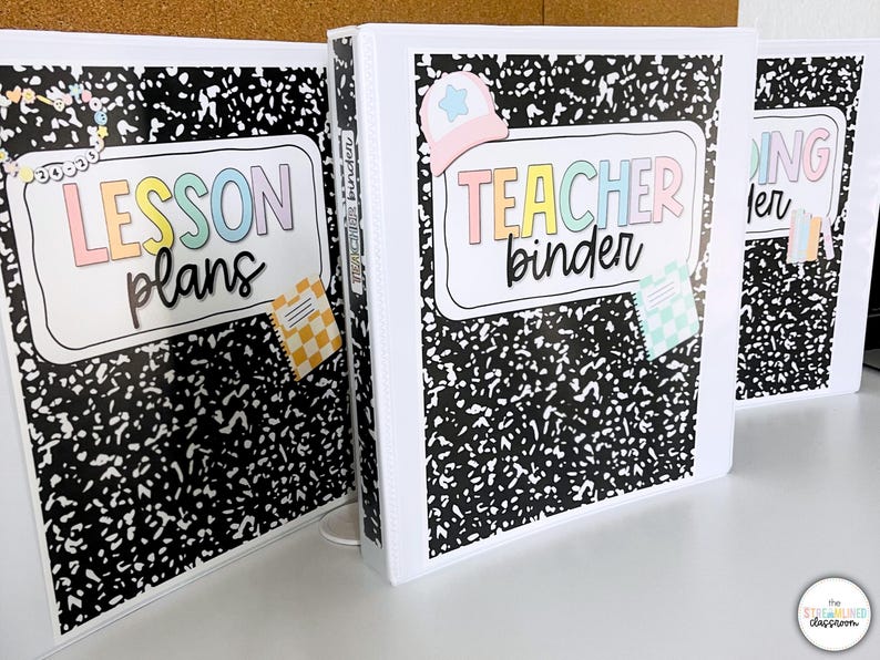 May include: Three white binders with black and white speckled covers. The binders have labels that read "LESSON plans", "TEACHER binder", and "DING ler" in colorful lettering. Decorative stickers of a hat and small notebooks are attached.
