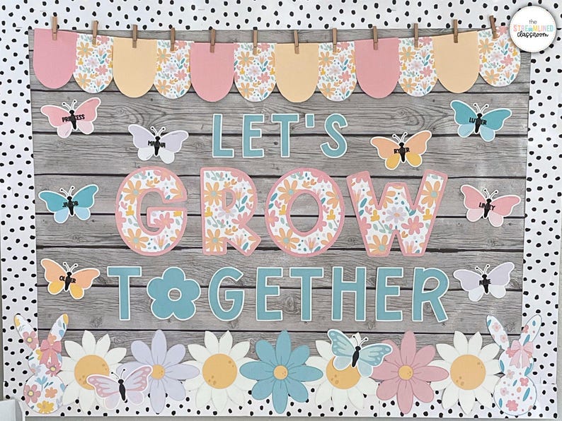 May include: A bulletin board with a woodgrain background and a floral theme. The bulletin board has a banner at the top with pink and yellow scalloped shapes. The words "Let's Grow Together" are displayed in large, teal letters. There are butterflies and flowers decorating the board.