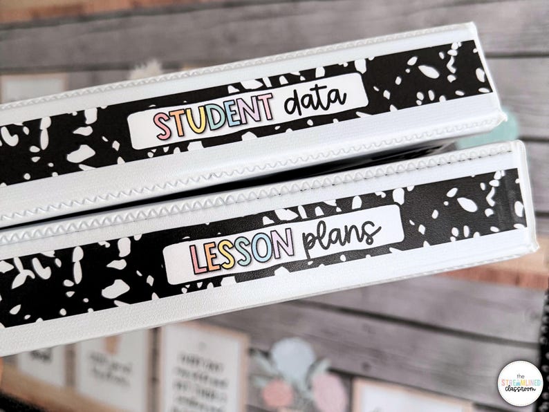 May include: Two white binders with black and white patterned accents. One binder reads "STUDENT data" in colorful letters, and the other reads "LESSON plans". The binders are likely for organizing classroom materials.