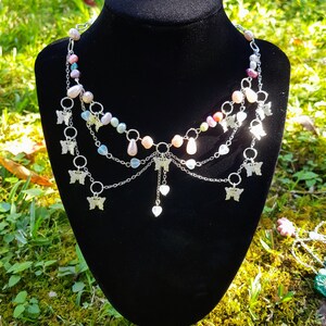 Pastel chandelier beaded necklace with butterfly and love heart drop charms.
