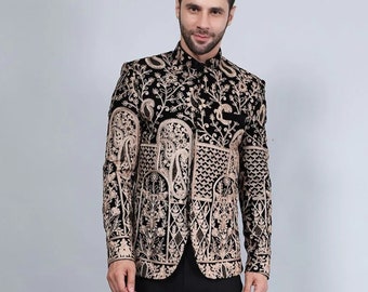 May include: A black embroidered jacket with intricate gold-colored patterns, paired with black trousers. The jacket features a mandarin collar and long sleeves. The image also shows brown leather shoes. The text "URdesigners" is visible.