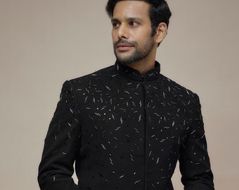 May include: A black blazer with a mandarin collar and intricate beading throughout. The blazer is worn over a black kurta and pants.