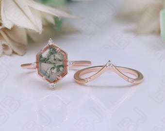 May include: A rose gold engagement ring set with a hexagonal green agate gemstone surrounded by small diamonds. The matching wedding band is a delicate rose gold band with a chevron design and small diamonds.