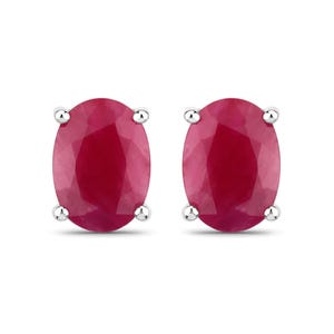 May include: A pair of oval-shaped ruby earrings set in silver. The earrings are a deep red color and have a polished finish.