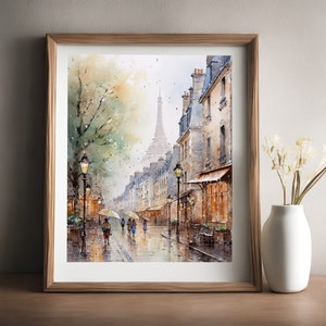 May include: A watercolor painting of a Parisian street scene with the Eiffel Tower in the distance. The street is lined with buildings and there are people walking with umbrellas. The painting is in a wooden frame.