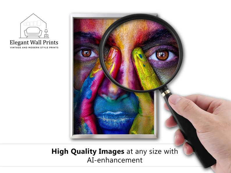 May include: A close-up of a person's face with colorful paint on their skin. A magnifying glass is being used to highlight the detail of the paint. The image is framed in a white frame with a silver border. The text "Elegant Wall Prints" is at the top of the image.