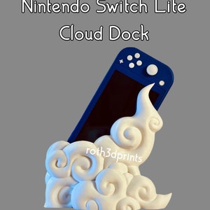 May include: A white cloud-shaped stand with a blue Nintendo Switch Lite console inside. The stand is designed to hold the console upright. The text "roth3dprints" is visible on the stand.