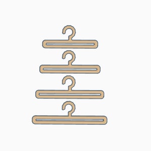 May include: Four brown plastic hangers with a hook on top, stacked on top of each other.