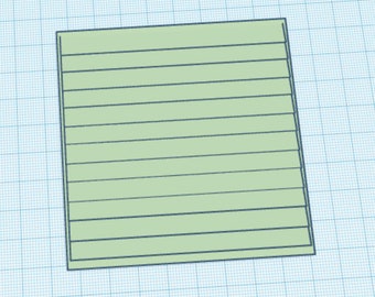 May include: A light green, rectangular shape with horizontal lines, resembling a notepad or a drawing. The object is set against a blue grid background, suggesting a design or technical drawing context.