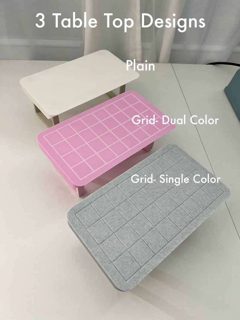 May include: Three table top designs: a plain white surface, a pink surface with a grid pattern, and a gray surface with a grid pattern. The text "Grid-Dual Color" is above the pink surface and the text "Grid-Single Color" is above the gray surface.