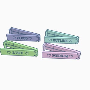 May include: Four different coloured plastic folding rulers with heart symbols and the words "Flood", "Outline", "Stiff", and "Medium" printed on them.