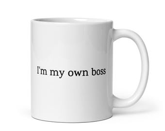 May include: White ceramic coffee mug with black text that reads "I'm my own boss".