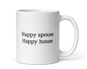 May include: White ceramic coffee mug with black text that reads "Happy spouse Happy house".