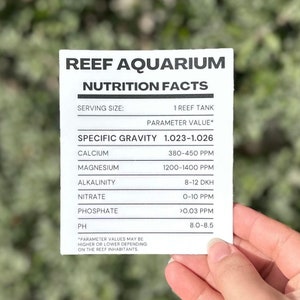 May include: A white card with the title "Reef Aquarium Nutrition Facts" and a table listing the ideal water parameters for a reef tank. The table includes specific gravity, calcium, magnesium, alkalinity, nitrate, phosphate, and pH.
